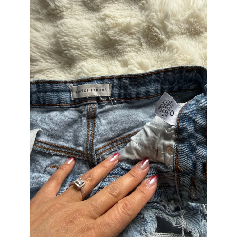 Preowned, Almost Famous light wash , distressed denim shorts, size 0